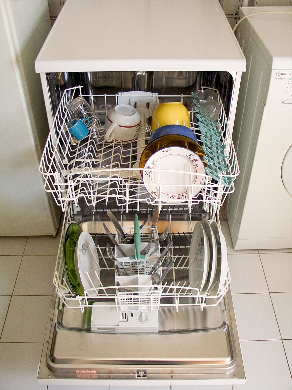 Open dishwasher with upper and lower racks loaded with dishes
